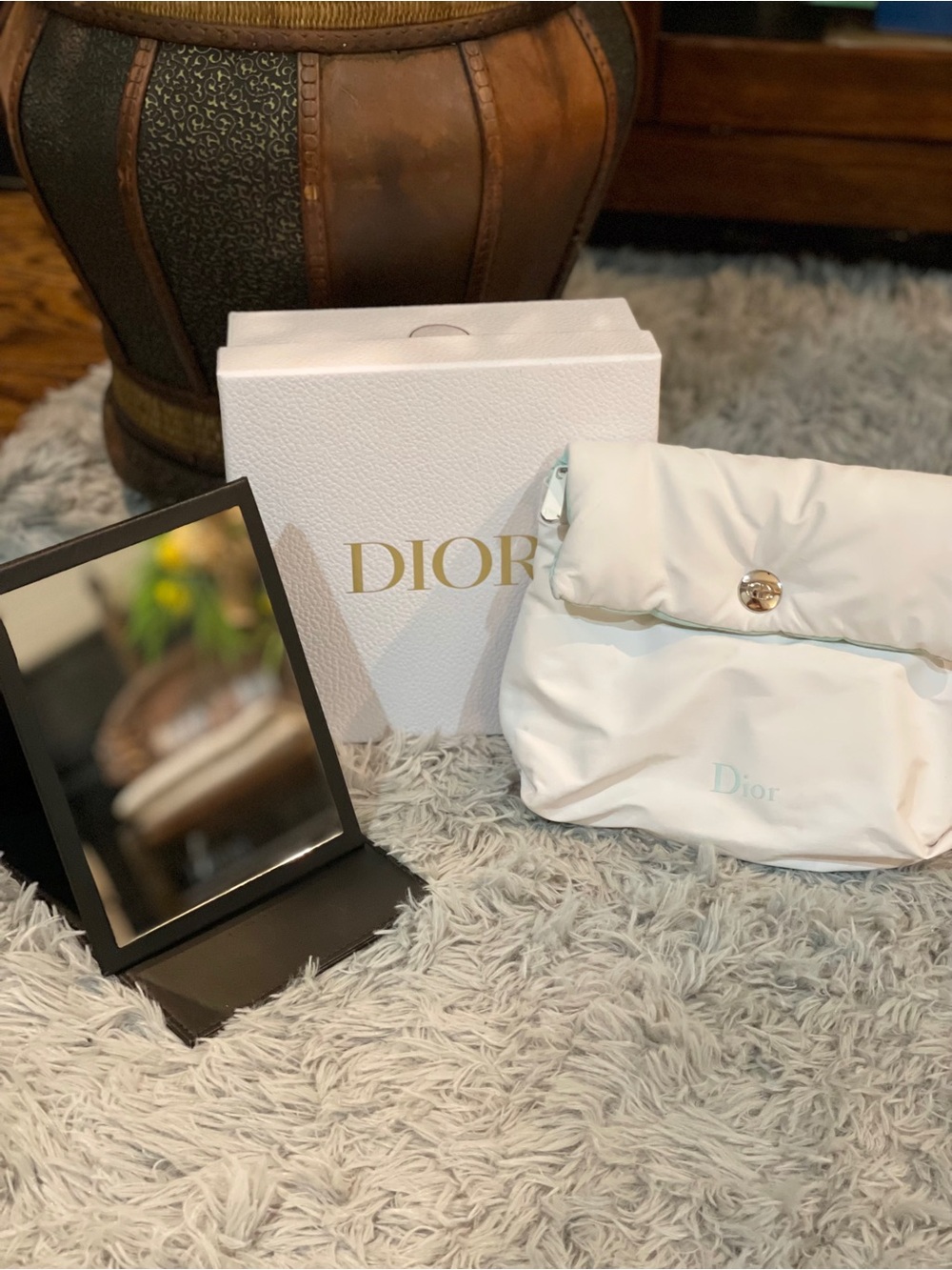 Dior white puffy cosmetic bag and Dior mirror